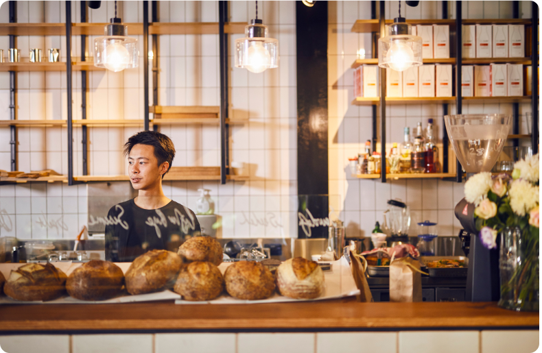 Man standing behind cafe 